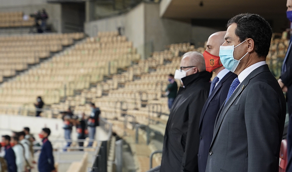 El presidente Juanma Moreno escucha con atención los himnos de España y Alemania antes del partido.