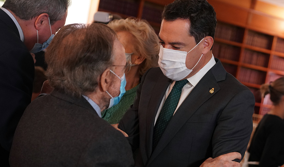 El presidente Juanma Moreno saluda al escritor y periodista Antonio Burgos, en la entrega del Premio Romero Murube.